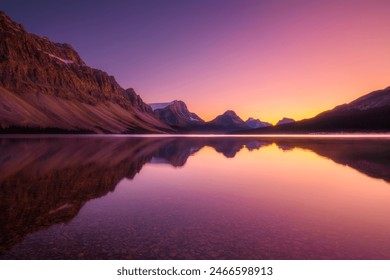 Mountain landscape at dawn. Reflections on the water surface. Lake and high peaks in a mountain valley at dawn. High rocky mountains. - Powered by Shutterstock