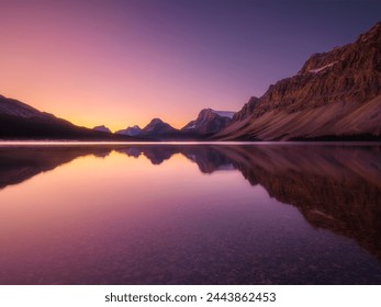 Mountain landscape at dawn. Sunbeams in a valley. Lake and high peaks in a mountain valley at dawn. Natural landscape with bright sunshine. High rocky mountains. - Powered by Shutterstock