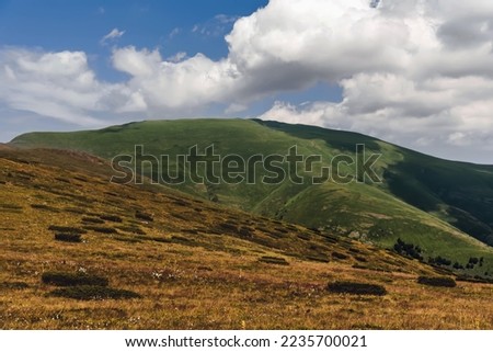 Mountain landscape with dramatic clouds in Old Mountain National park, nature preserve between Serbia and Bulgaria. Stara Planina hillside on sunny summer day.