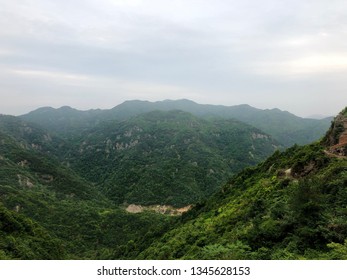 Mountain landscape. Green hills in China. Chinese landscapes. The forest, the mountain area in cloudy day. A view in a distance of mountain tops - Shutterstock ID 1345628153