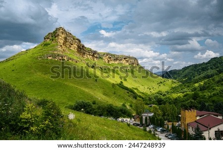 Mountain landscape at Honey Waterfalls canyon near Kislovodsk, Russia. View of scenic green forest and sky in Russian Kavkaz in summer. Concept of nature, travel, tourism in Caucasian Mineral Waters.