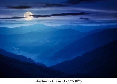 Mountain Landscape On A Summer Night. Hills Rolling From The Valley Up In To The Distant Ridge. View Of The Summer Scenery In Full Moon Light