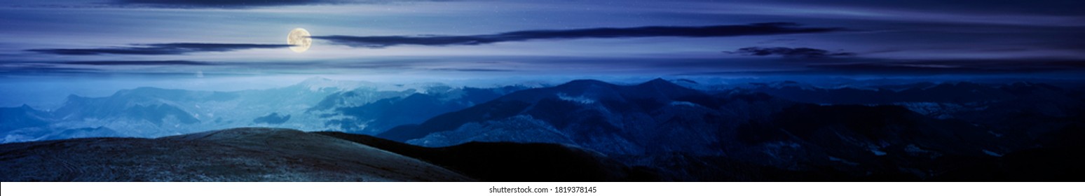 Mountain Landscape Panorama At Night. Hills Rolling From The Valley Up In To The Distant Ridge. View Of The Summer Scenery In Full Moon Light