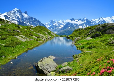 Mountain landscape reflected on the surface of the lake. Nature Reserve Aiguilles Rouges, French Alps, France, Europe.