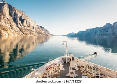 Mountain landscape with reflection.  Expedition cruise ship in Sam Ford Fjord, Baffin Island in Nunavut, Arctic Canada - Shutterstock ID 2167711229