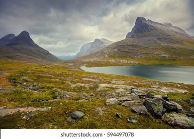 Mountain landscape. Rocky shore of mountain lake in rainy autumn morning. Beautiful nature Norway. - Powered by Shutterstock
