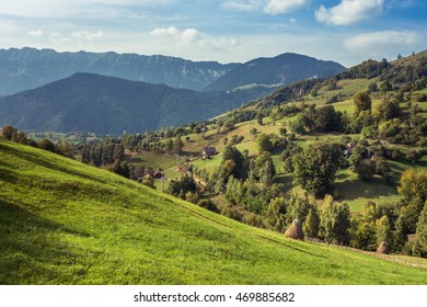 Mountain landscape in Romania. Rural Romanian landscape. Landscape in Magura village with the Carpathian Mountains in the background. Traditional Romanian village and mountains panorama. 
