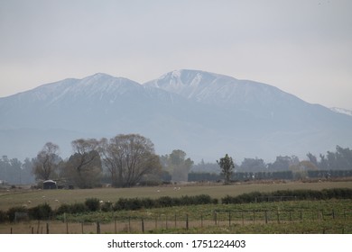 Mountain landscape. Snow just starting to cover the mountains as the seasons change into winter. Temuka, New Zealand