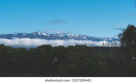 Mountain Landscape snowy peaks covered in fog low cloud in New Zealand - Powered by Shutterstock