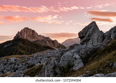 Mountain landscape - sunrise. The rock looks like a silhouette of a dinosaur. - Shutterstock ID 1572594304