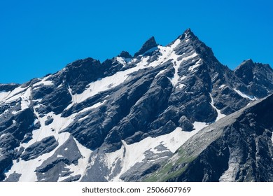 mountain landscape, view of sharp rock peak with snowfields and glaciers