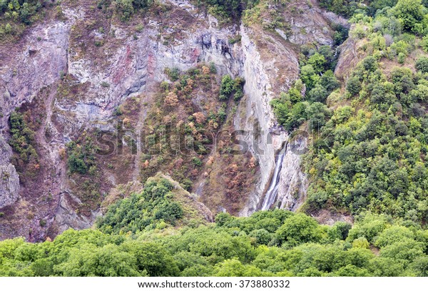 Mountain landscape waterfall flows down the cliff. The\
landscape in Armenia (Tatev). The canyon next to the cable car\
\