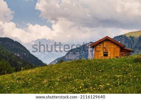 mountain landscape with wooden mountain cabine inside Val San Nicolò, Val di Fassa, Dolomites, Italy