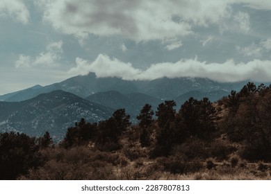 Mountain layers in the midday sun  with clouds overhead