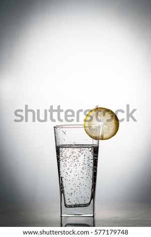  Mountain mineral pure mountain water with gas bubbles and a lemon slice and spray tonic refreshing sports drink.