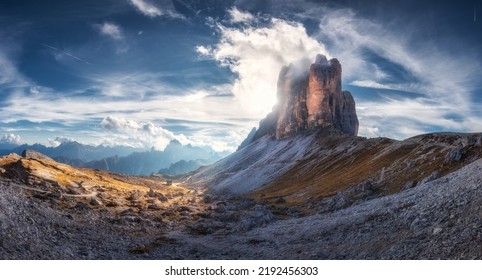 Mountain pass and blue sky with clouds at sunset in autumn. Beautiful panoramic landscape with rocks, alp mountains, stones, path, house, grass on hills. Tre Cime, Dolomites, Italy. Colorful scenery - Powered by Shutterstock