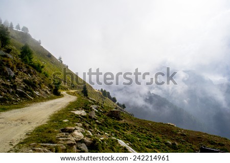 Mountain path in the mist during a cloudy morning, Italian Alps