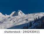 The mountain peak Aiguille du Tour and the Glacier du Tour covered by recent snowfall in winter before sunset in Chamonix valley in France
