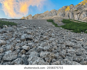 Mountain peak Begunjscica bathed in warm sunrise light seen from Loibl Pass in Karawanks, border Slovenia Austria. Wanderlust in Austrian Slovenian Alps. Tranquil atmosphere in alpine wilderness. Hike - Powered by Shutterstock