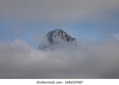 mountain peak between the clouds