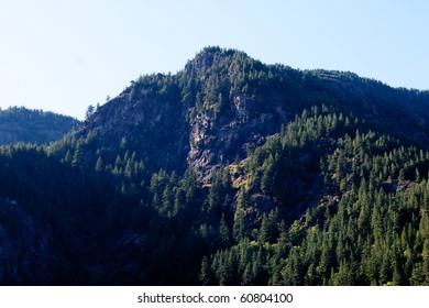 A mountain peak in the Cascade mountain range covered in evergreen trees