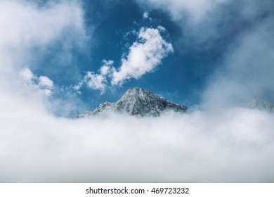 Mountain Peak Reaching Through the Clouds