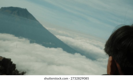 Mountain Peak Rises Above Clouds, Inspiring View From Above, a Person Gazes, Serene Nature Escape Landscape