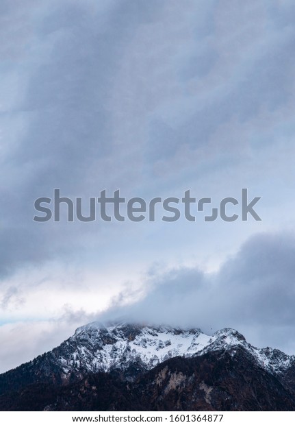 mountain peak with snow in foggy\
cloudy weather time highland winter wallpaper pattern landscape\
vertical picture and empty copy space for your text here\
