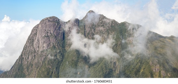 mountain peak through the clouds