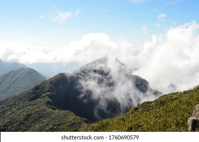 mountain peak through the clouds