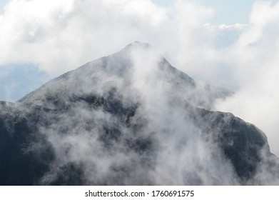 mountain peak through the clouds