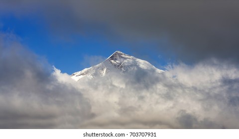 mountain peak through the clouds     