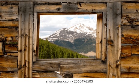 Mountain peak view through window of abandoned building 