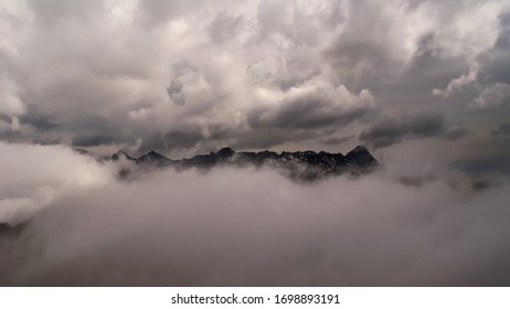 
mountain peaks in the clouds