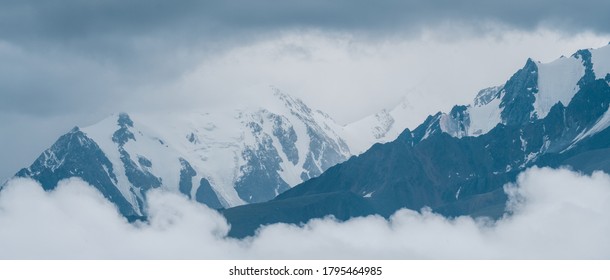 Mountain peaks in the clouds. Panoramic view. - Shutterstock ID 1795464985