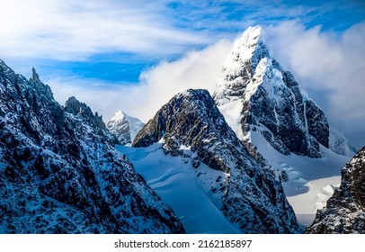 Mountain peaks covered with snow. Snowy mountain peaks. Mountain peak in snow. Winter mountain peak snow
