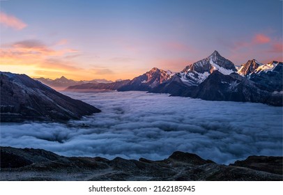 Mountain peaks in the fog at dawn. Foggy mountains at dawn. Beautiful sunrise in foggy mountains. Mountain morning fog at dawn - Shutterstock ID 2162185945