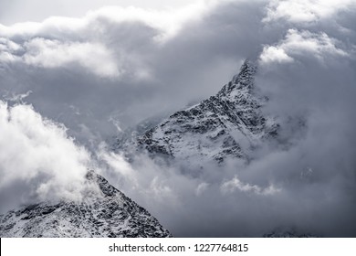 Mountain peeks surrounded in clouds.