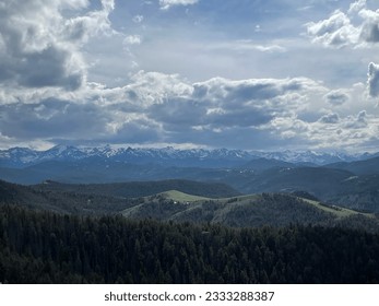 Mountain range with clouds in the sky and snow
