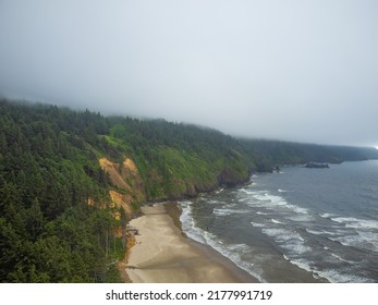 Mountain Range Covered With Pine Forest Near The Sandy Shore Of The Ocean. Light White Waves And Ripples On The Water. Beautiful Seascape. There Are No People In The Photo. Banner, Postcard.