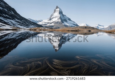A mountain range covered in snow under a cloudy skyc
