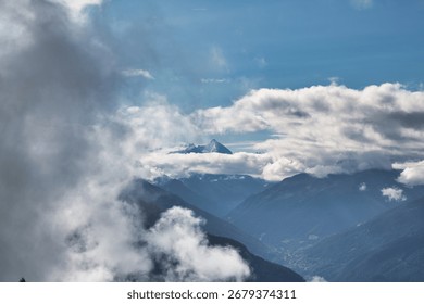 A mountain range with a few clouds