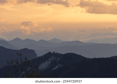 Mountain range with mist and partly cloudy sky. Landscape backdrop photo.