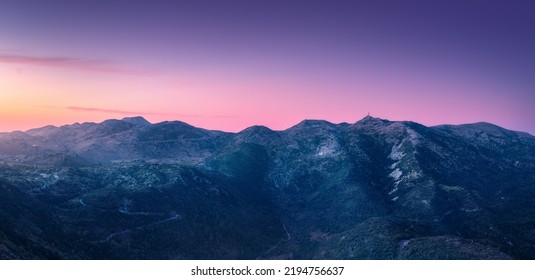 Mountain Range At Night In Summer. Beautiful Landscape With Forest On Hills, Rocks And Pink Sky With Sunlight At Sunset In Greece. Top View Of Mountain Peaks At Twilight. Nature Background. Scenery