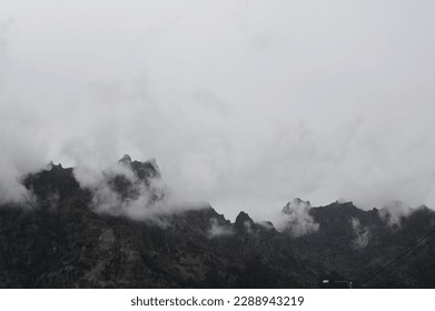 Mountain range and peaks covered in clouds, fog and mist on Madeira Island , Portugal