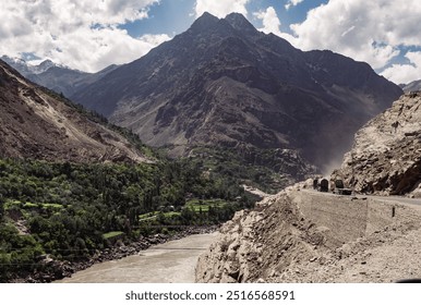 A mountain range with a river running through it and a dangerous road