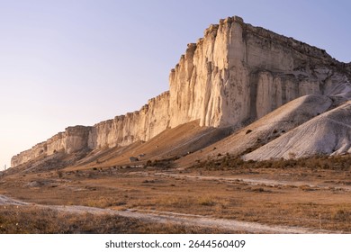 Mountain range with a road running through it. The road is dirt and there are no cars on it