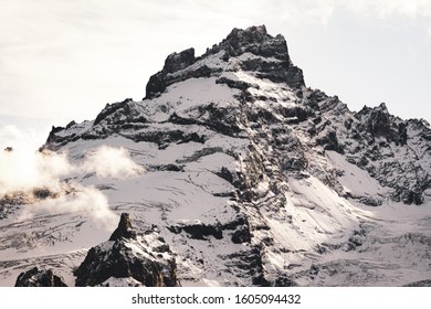 Mountain Range with Snow and Clouds