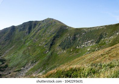 A mountain range with a steep cliff.