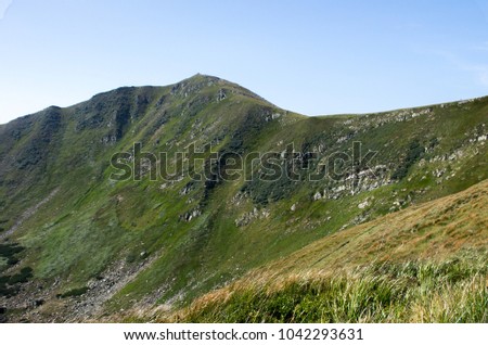 A mountain range with a steep cliff.
